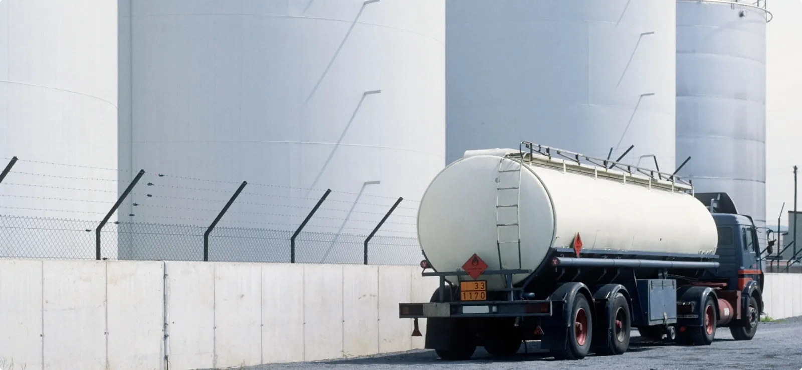 Tanker truck near chemical storage silos ensuring safe logistics and material distribution