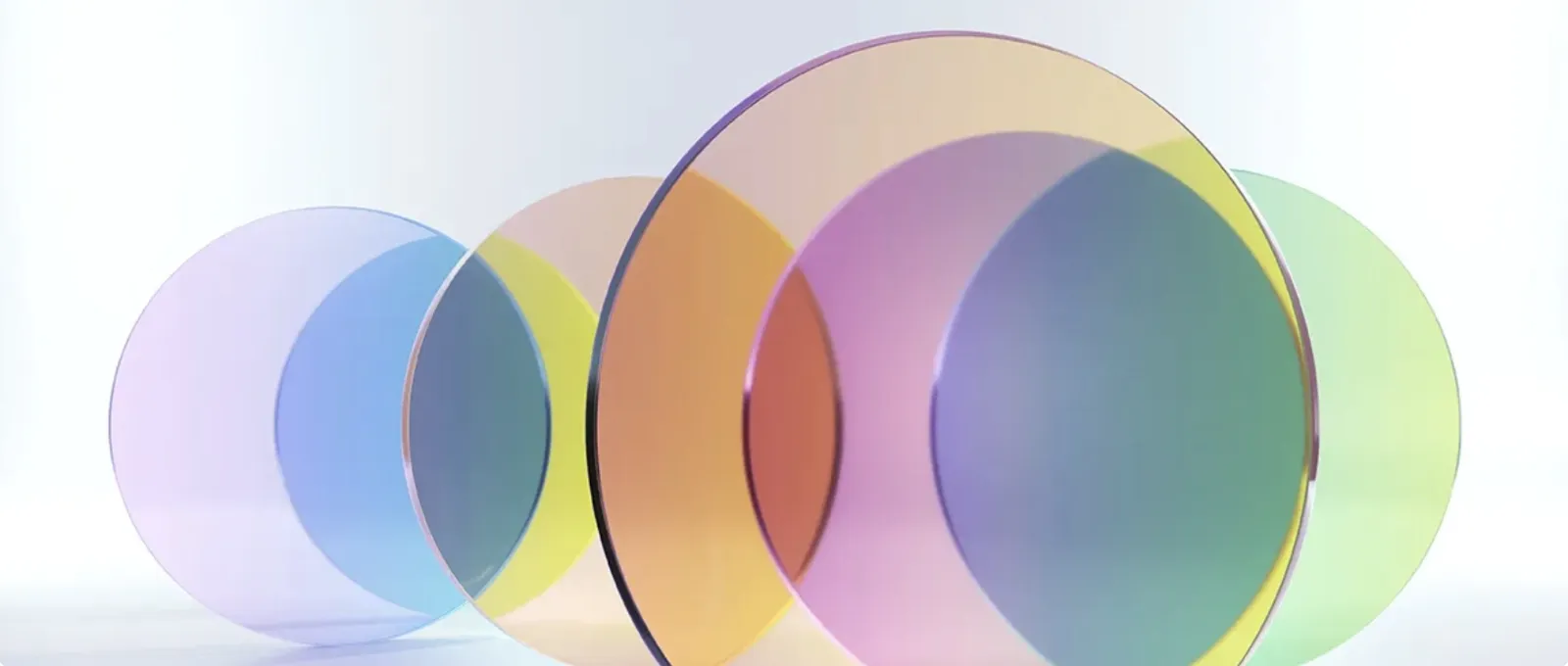 Colorful translucent glass discs symbolizing innovation and advanced material technology