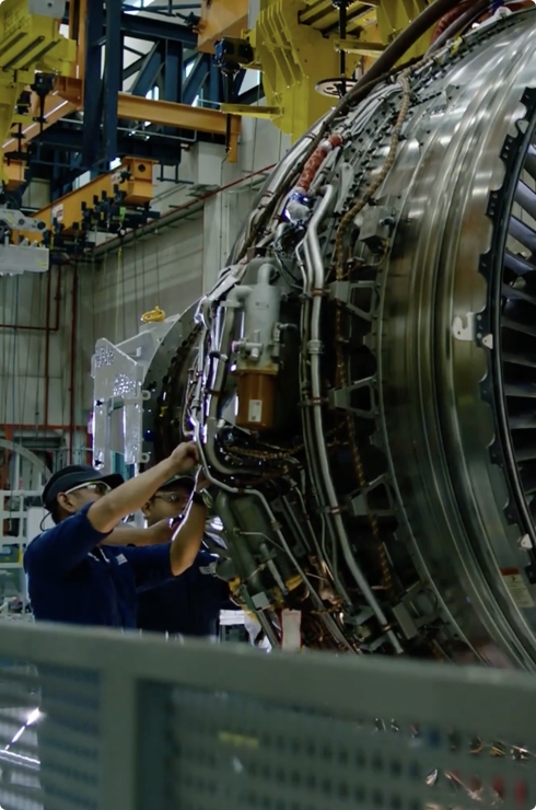 Technician repairing complex aircraft engine systems showcasing advanced maintenance and engineering