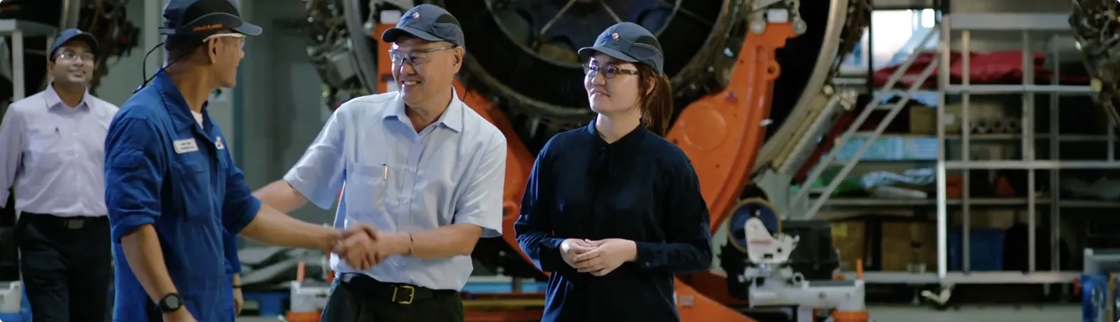 Engineering team collaborating in aerospace plant to drive innovation and operational reliability