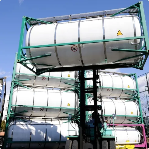 Forklift handling stacked chemical tanks for efficient material storage and transport operations