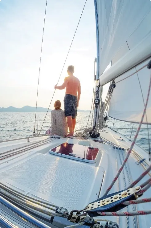 Couple sailing into sunset symbolizing strategic vision and smooth journey ahead