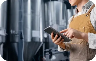 Brewery operator uses a tablet to review schedules and tank telemetry.