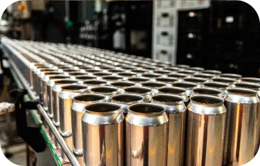 Aluminum cans on a conveyor during filling and inspection.
