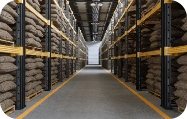 Rows of stacked burlap sacks in a spacious warehouse storing coffee beans.