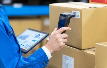 Worker scanning barcode with tablet for inventory tracking