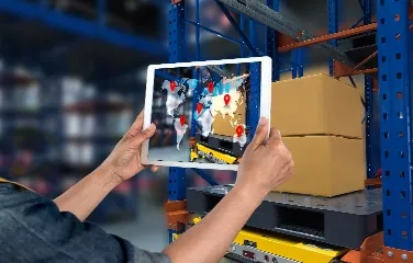 Worker using tablet showing global logistics tracking map