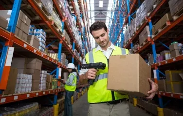 Warehouse worker scanning box for inventory tracking