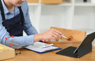 Manager analyzing online sales and stock on tablet