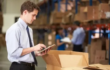 Supervisor using tablet for warehouse order verification