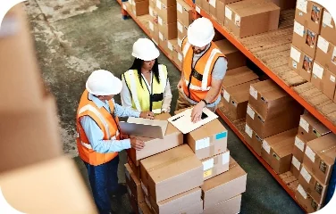 Warehouse team reviewing boxes and shipment scenarios together