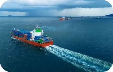 Container ship carrying stacked containers across the ocean, illustrating global inventory movement.