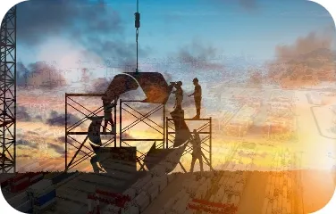Workers perform assembly and crane operations during construction of an industrial processing facility.