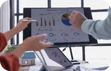 Colleagues discussing procurement performance charts during a meeting.