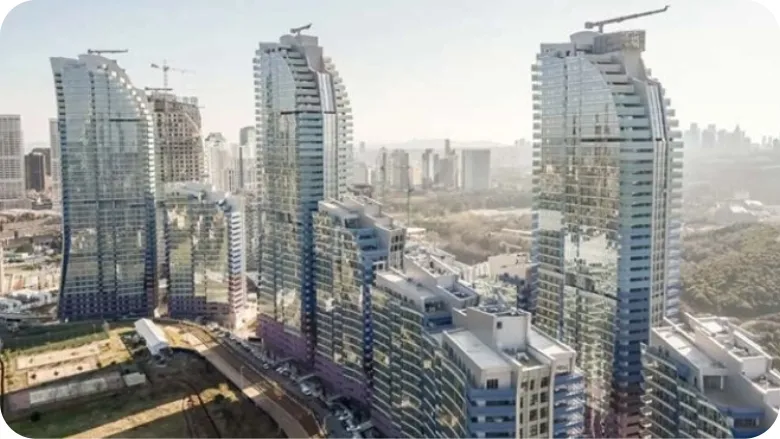 Aerial view of modern high-rise buildings, representing large-scale operations and planning complexity.