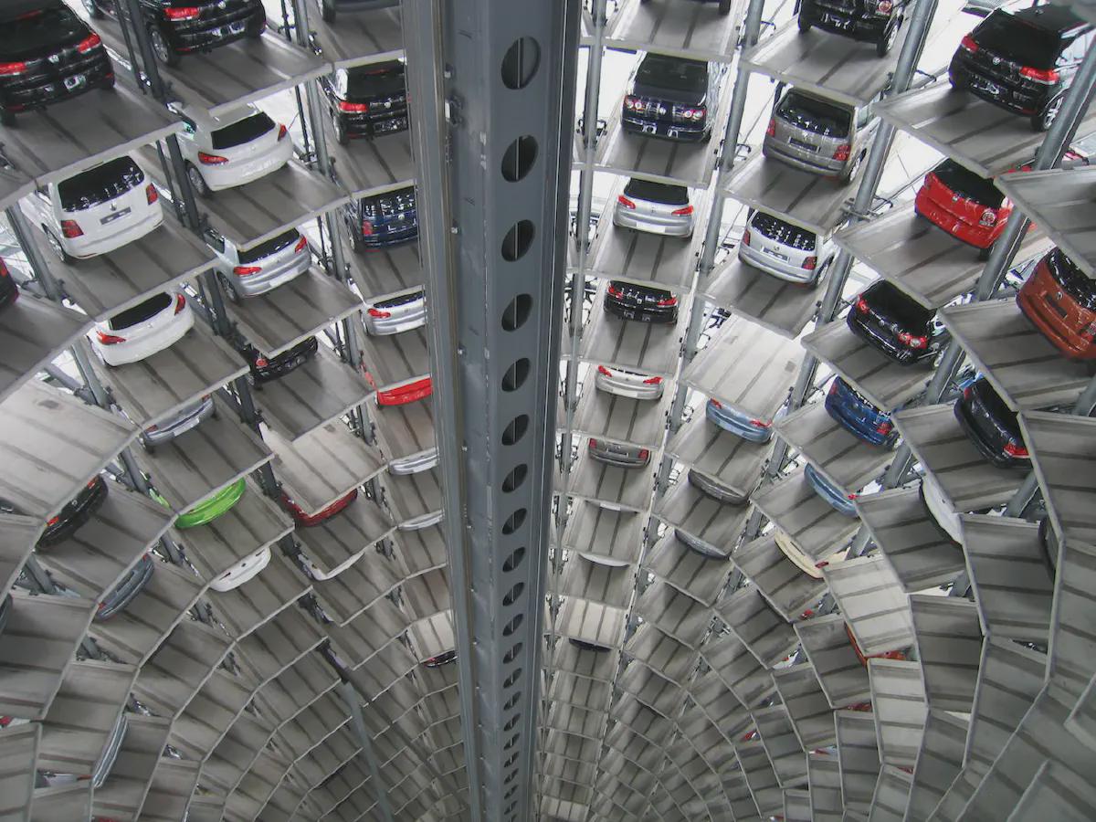 Automated car storage facility with vehicles stacked in vertical layers for optimized space and efficiency