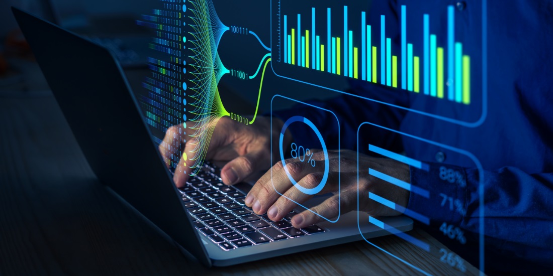 Hands typing on laptop with AI analytics dashboard showing data insights for customer-centric supply chain planning