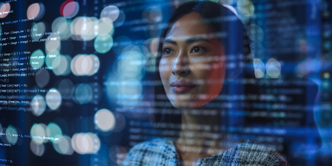 Female data analyst examining code and AI insights for smarter supply chain decision-making