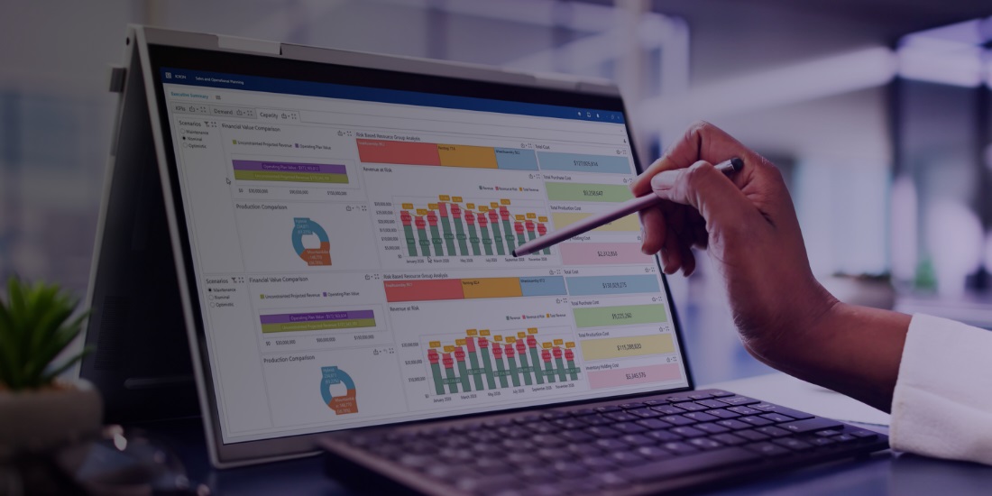 Manager reviewing supply chain S&OP process data on laptop