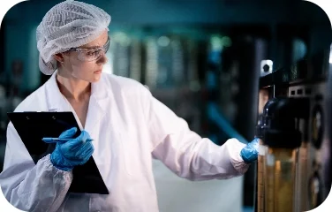 A quality analyst inspects equipment to support compliance and regulatory alignment.