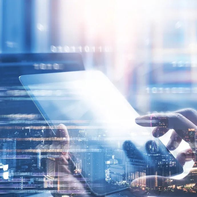 Digital interface overlay showing data connectivity as a person uses a tablet for industrial operations