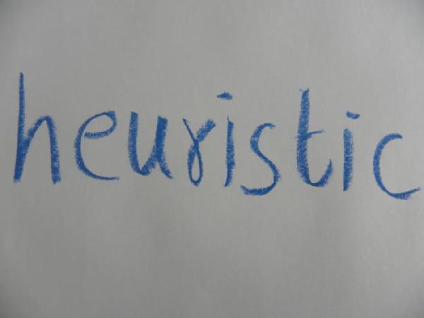 Word heuristic written on paper representing different decision-making methods in supply chain optimization