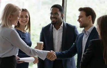 Business professionals networking and shaking hands during supply chain discussions